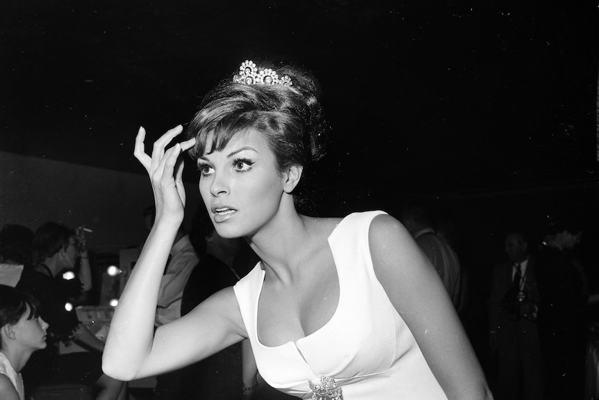 A black and white image of Raquel Welch wearing a tiara in 1962.
