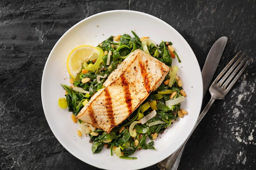 A plate of vegetables and fish