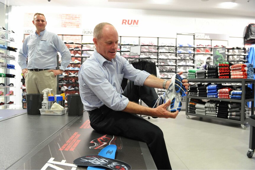 Premier Campbell Newman getting trying on new shoes for his daily run