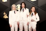  Phoebe Bridgers, Lucy Dacus and Julien Baker in matching white suits.