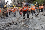 A rescue worker cuts iron rods at the Kolkata flyover collapse site