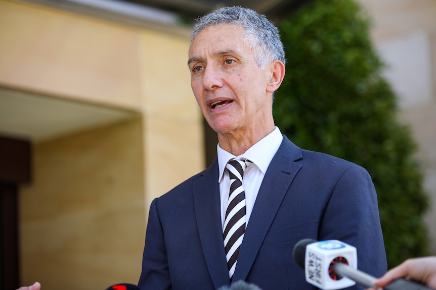 A head and shoulders shot of WA Racing and Gaming Minister Tony Buti speaking outside state parliament.