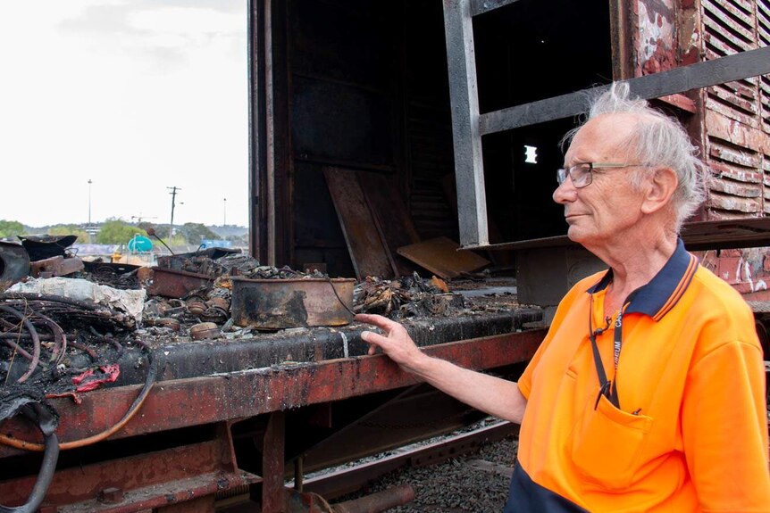 John Cheeseman inspects burnt out carriage