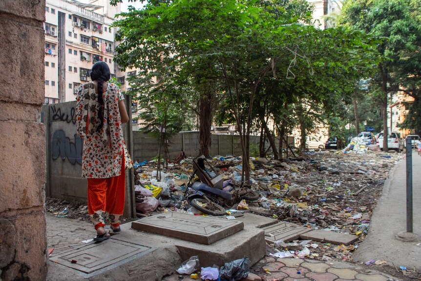 A woman looking out over a sea of rubbish