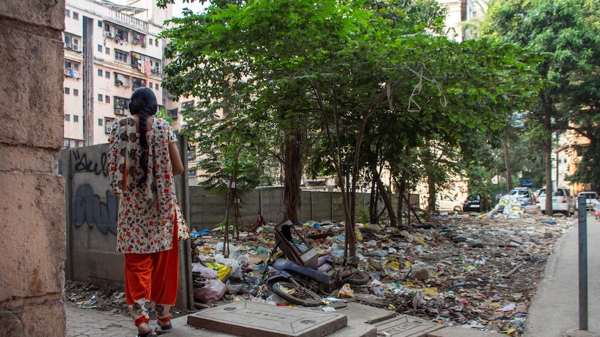 A woman looking out over a sea of rubbish