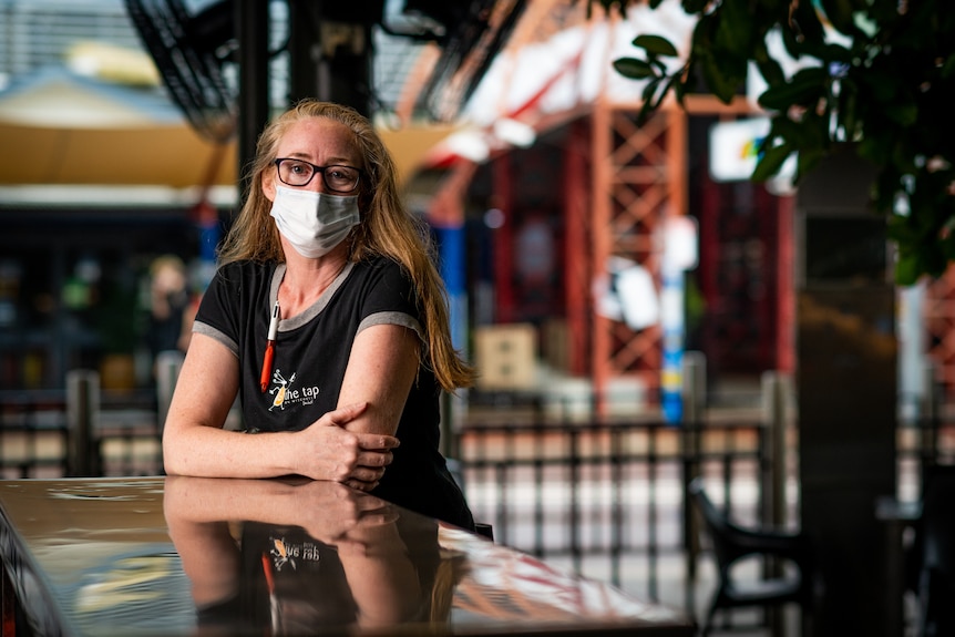 The Tap manager Kylie Arthur sitting at a table in the alfresco area of the bar.