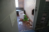 Toilets have been ripped out of walls in a damaged prison cell