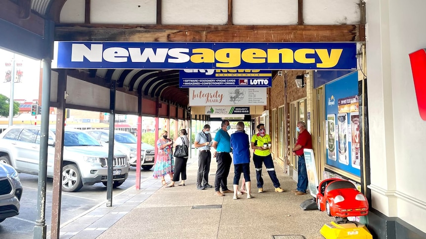 Locals cue outside the news agency 