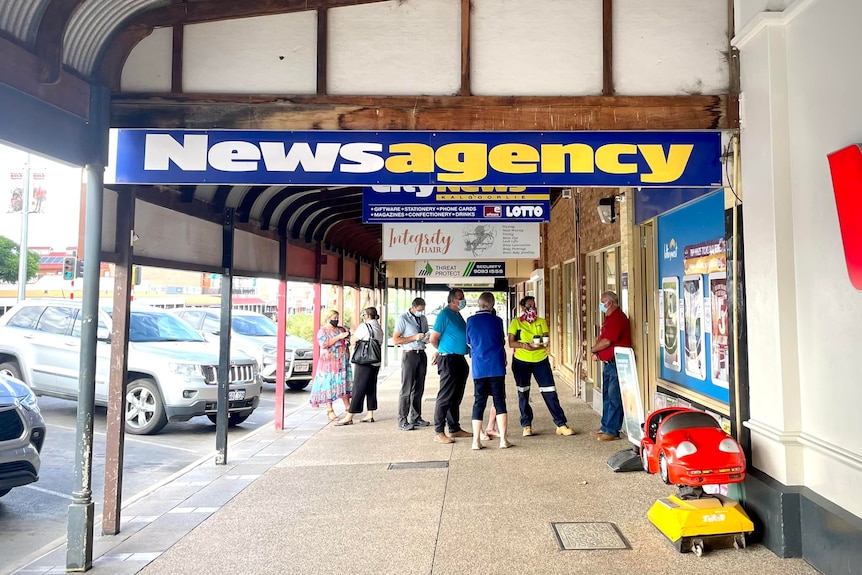 Locals cue outside the news agency 