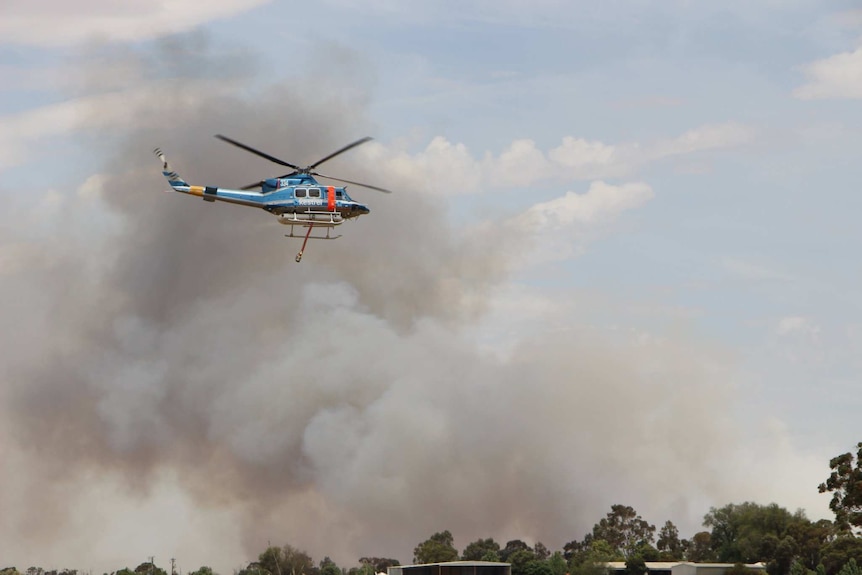 Firefighters attack a blaze near Swan Hill from the air.
