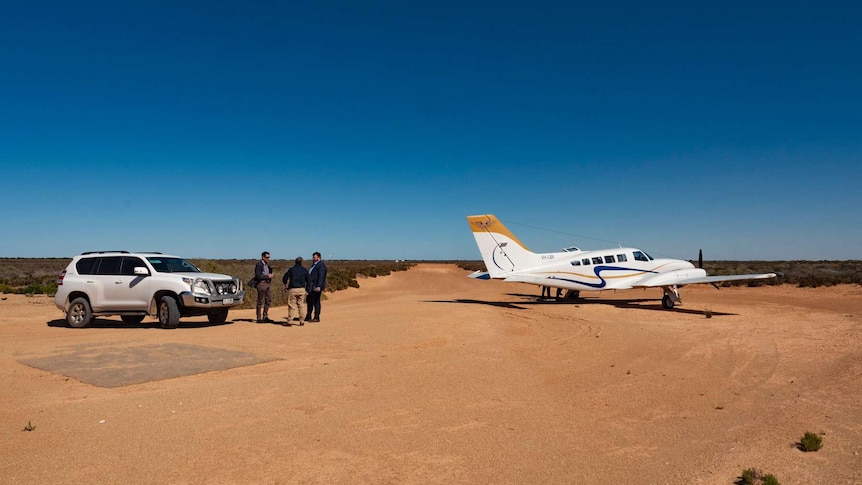 A plane parked on a remote airstrip.  