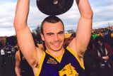 Former Essendon rookie Hal Hunter with cup