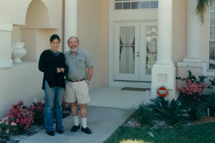 Dark-haired woman and bearded man stand together