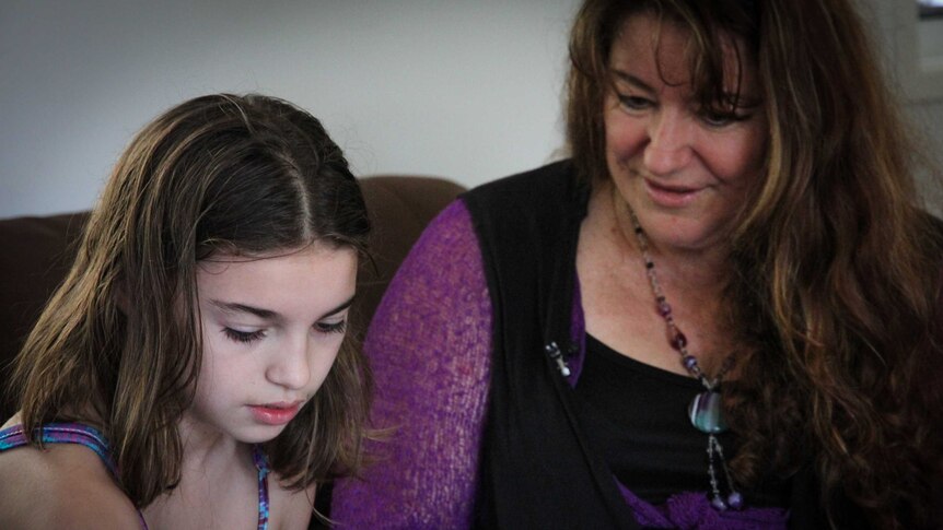 Jasmin, who has Dravet syndrome, sits with her mother Sue.