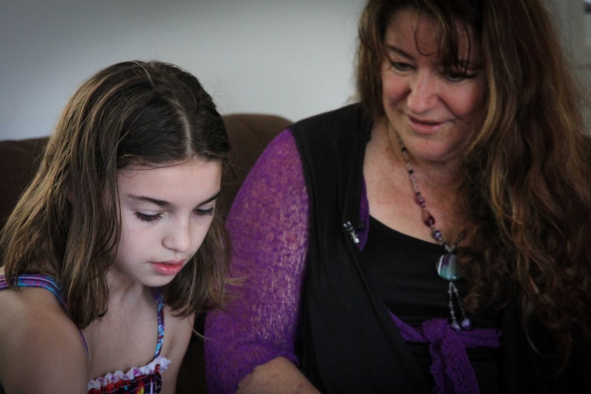 Jasmin, who has Dravet syndrome, sits with her mother Sue.