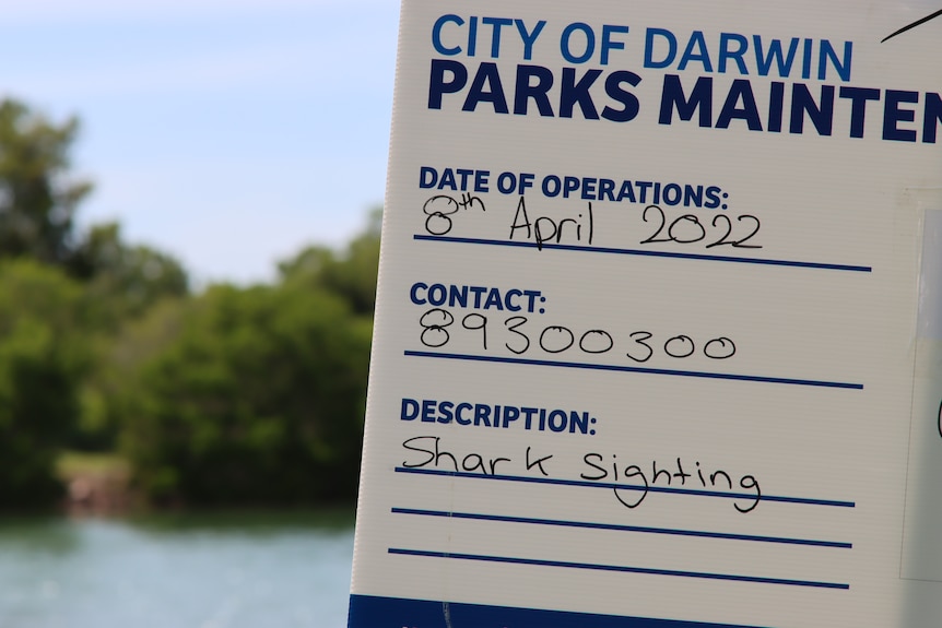 a sign warning of a shark sighting