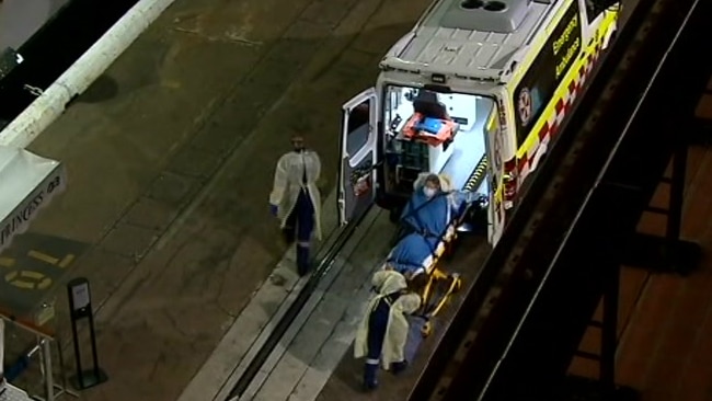 An ambulance and stretcher with someone on it, seen from above.