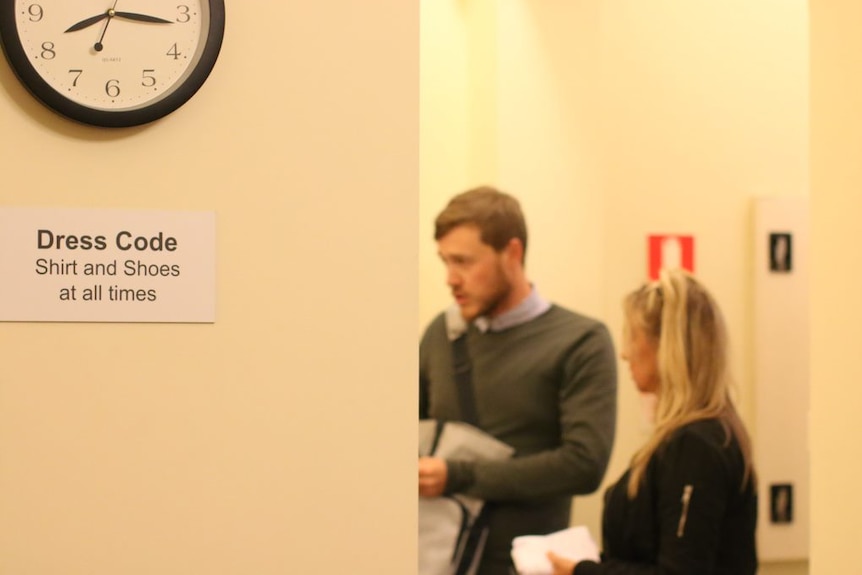 A clock on the wall shows 8:15pm. A sign says "dress code, shirt and shoes at all times". Anne-Marie and Chris in background