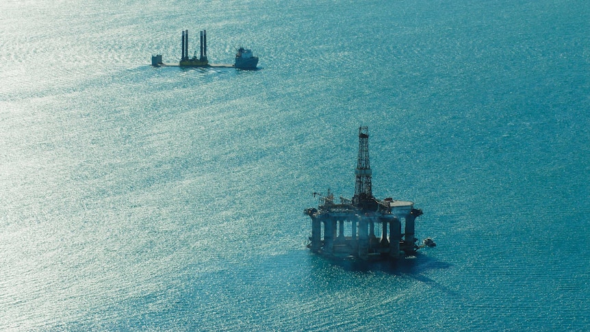 The semisubmersible offshore drilling rig in the foreground and a oil rig construction vessel on the North West Shelf.