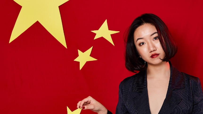 Journalist Vicky Xiuzhong Xu holds one of the stars on the Chinese flag.