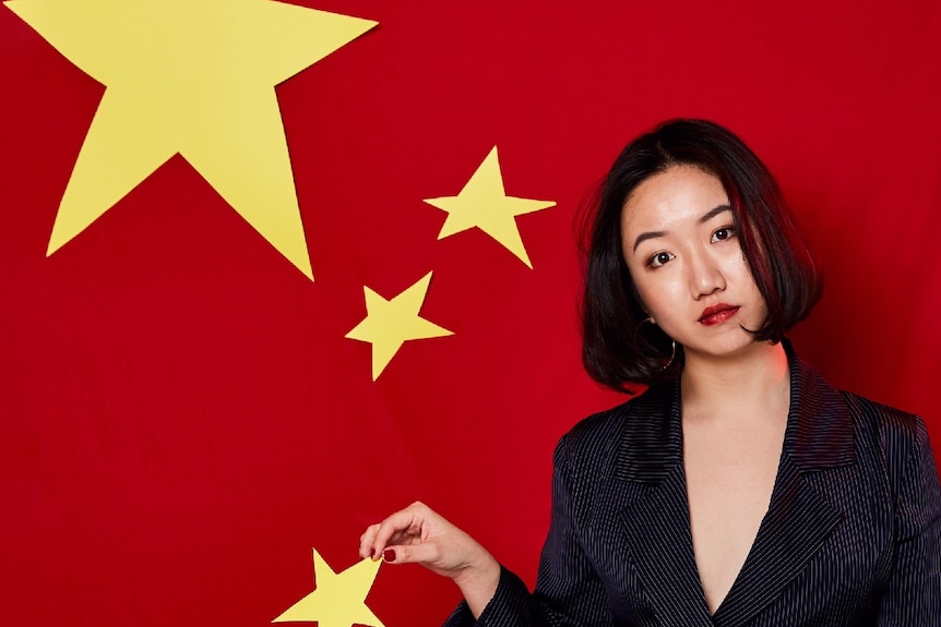 Journalist Vicky Xiuzhong Xu holds one of the stars on the Chinese flag.