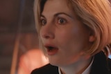 A close-up still from a video of Jodie Whittaker after the Doctor Who regeneration.