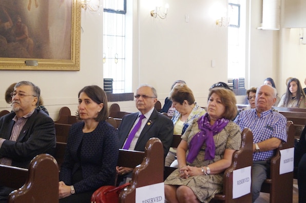 A group of people sitting on pews.