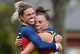 Anne Hatchard and Ebony Marinoff of Adelaide embrace