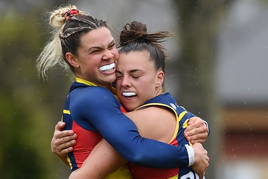 Anne Hatchard and Ebony Marinoff of Adelaide embrace