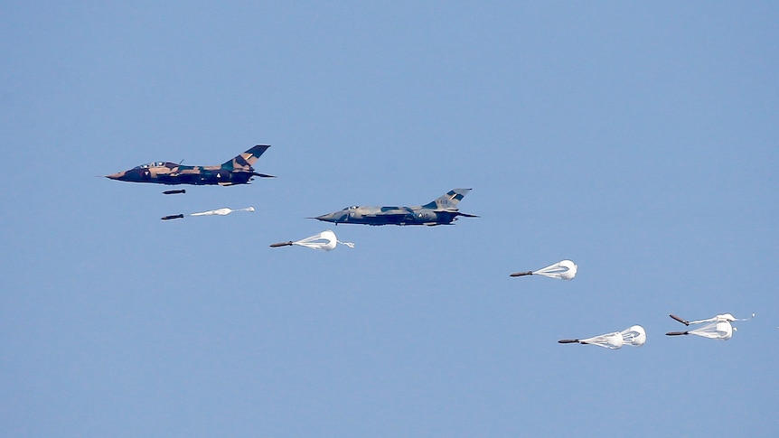 A view of fighter jets against a blue sky