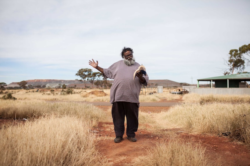 Ninga Mia pastor and long-time resident Geoffrey Stokes in a field near his church.