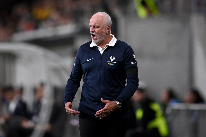 Football coach Graham Arnold on the touchline, screaming instructions to his players