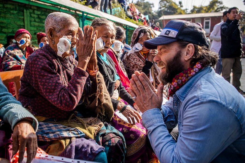 Edgerton laughs with locals