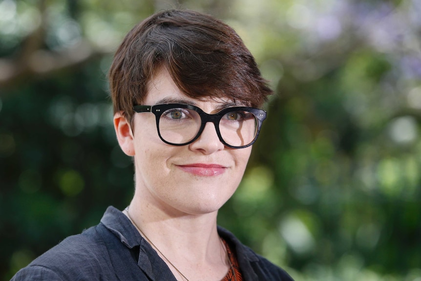 Amy MacMahon smiles to the media during a press conference.