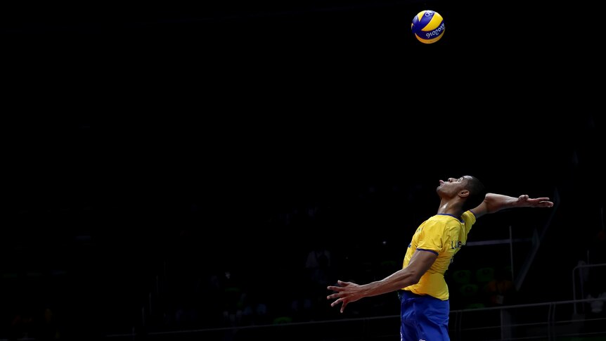 Ricardo Lucarelli pokes his tongue out as he prepares to spike the ball during a volleyball match at Rio.