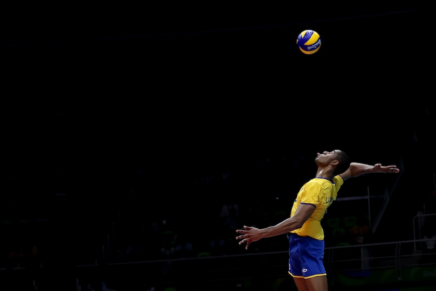 Ricardo Lucarelli pokes his tongue out as he prepares to spike the ball during a volleyball match at Rio.