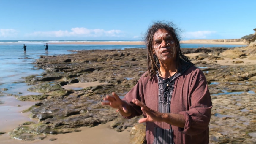 Gumbaynggirr elder Michael 'Micklo' Jarret stands beside the sea