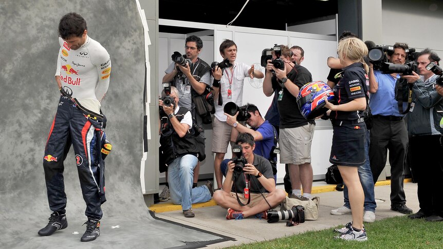 Mark Webber gets into racing suit for driver portrait ahead of the Australian F1 Grand Prix.