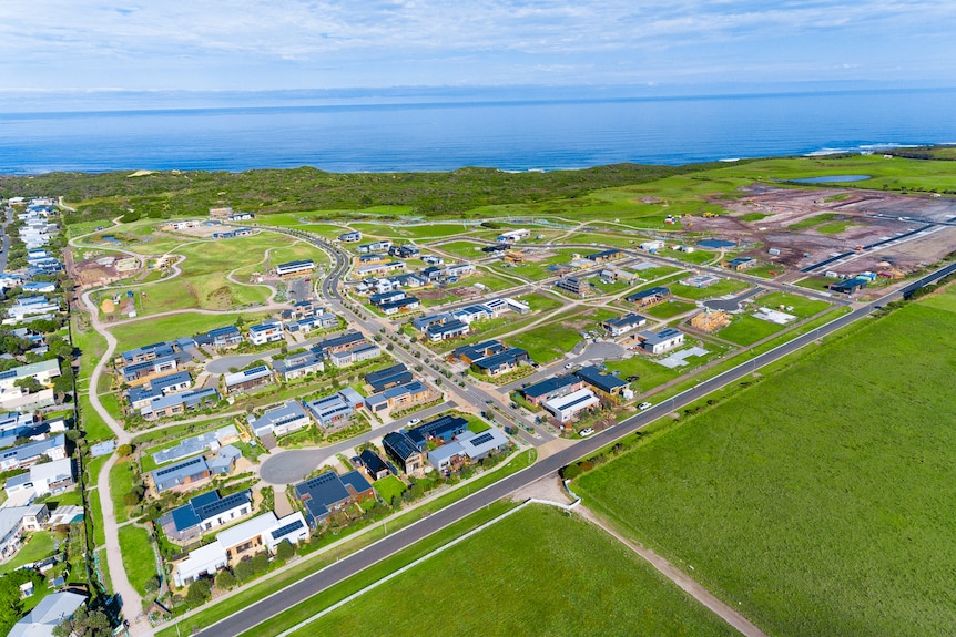 An aerial shot of a housing estate under construction in green fields