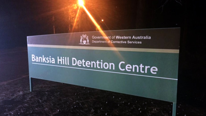 A sign outside the Banksia Hill detention centre, pictured at night.