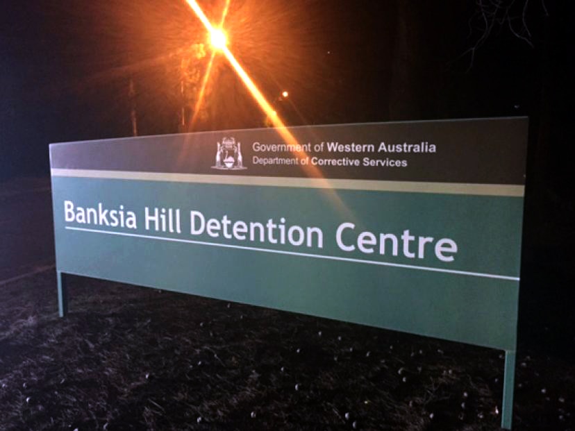 A sign outside the Banksia Hill detention centre, pictured at night.