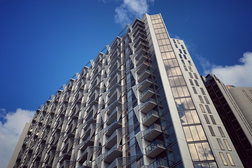 A large apartment block on a sunny day.