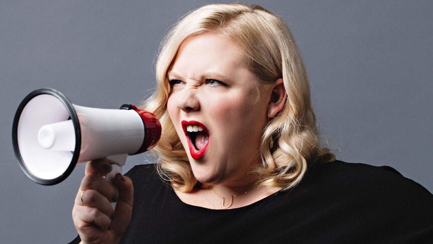 Headshot of author and activist Lindy West holding and screaming through a megaphone