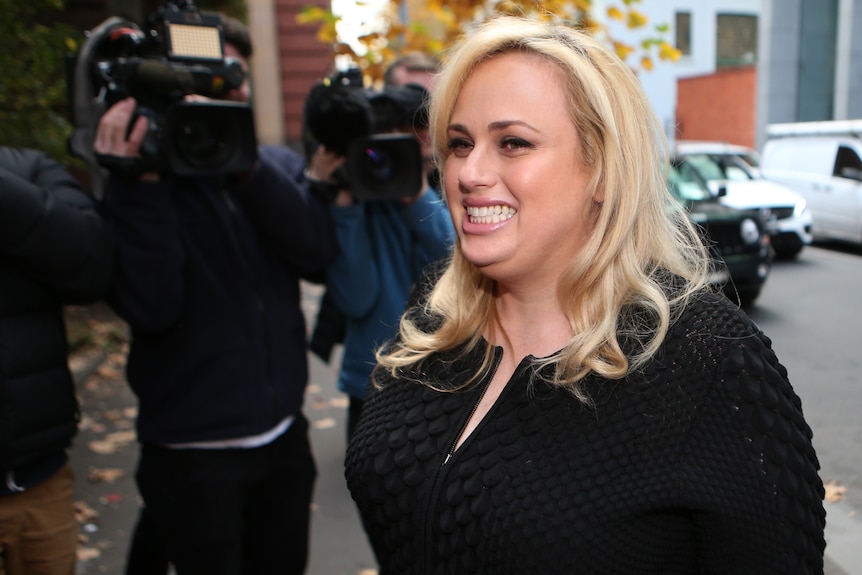 Actress Rebel Wilson smiles outside the Supreme Court in Melbourne.