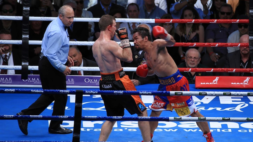 Manny Pacquiao aims a punch at Jeff Horn