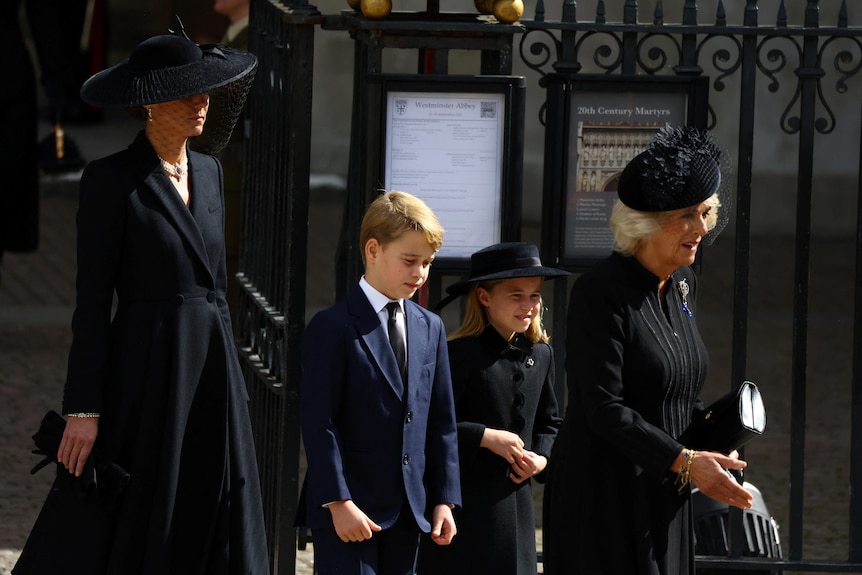 George and Charlotte walk with Camilla and Kate - all dressed in black 