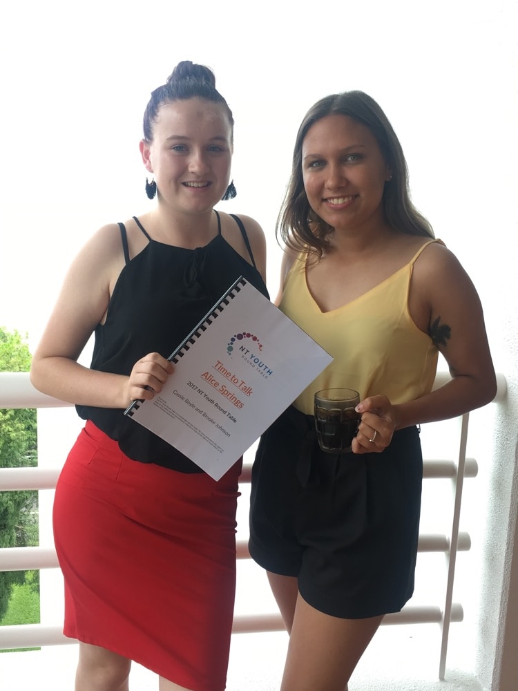 Two young girls standing together