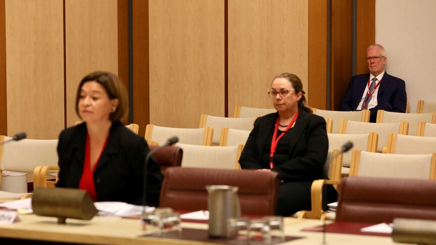 Former chairman Justin Milne watches managing director Michelle Guthrie giving evidence to a Senate inquiry into the ABC.