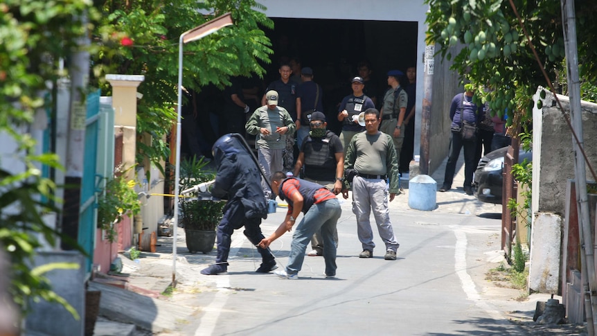Indonesian bomb squad police defuse bombs they found during terrorism raids in Solo, Central Java.