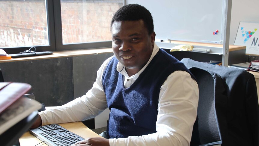 Northern Tasmania Development Corporation population attraction coordinator Edward Obi at his desk, May 2019